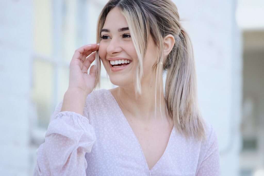 Young women smiling as she gazes out.